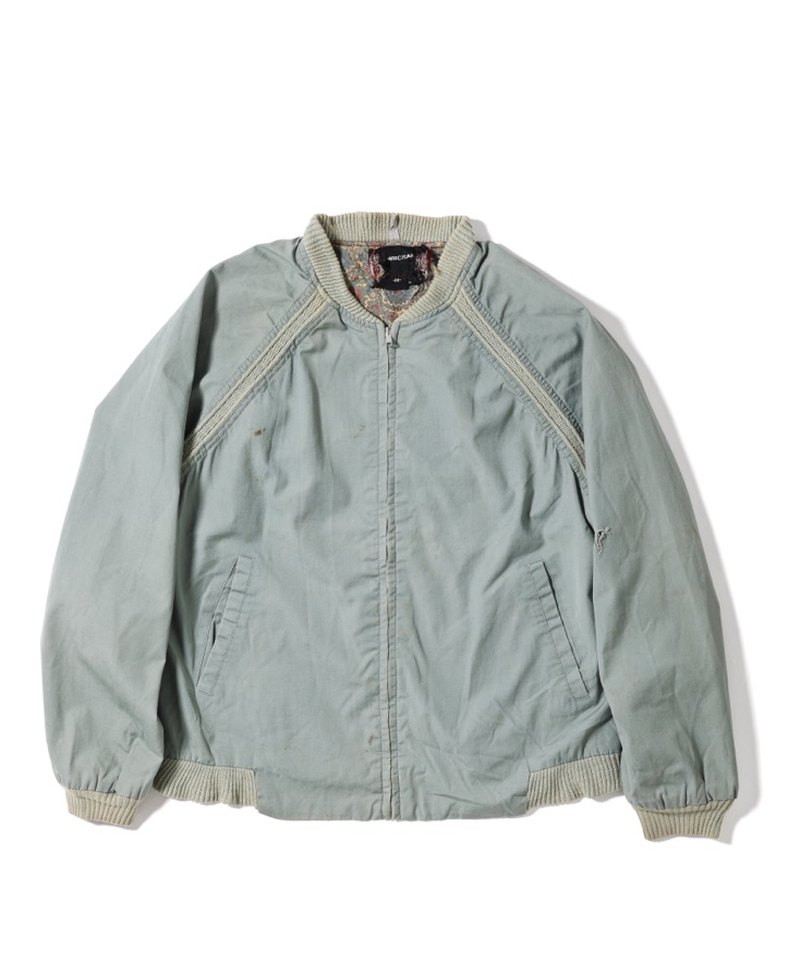 Front of a vintage raglan-sleeve jacket with rib-knit trim along the raglan seams, a rib-knit collar and cuffs, a front zipper and slanted pockets on the left and right at the waist