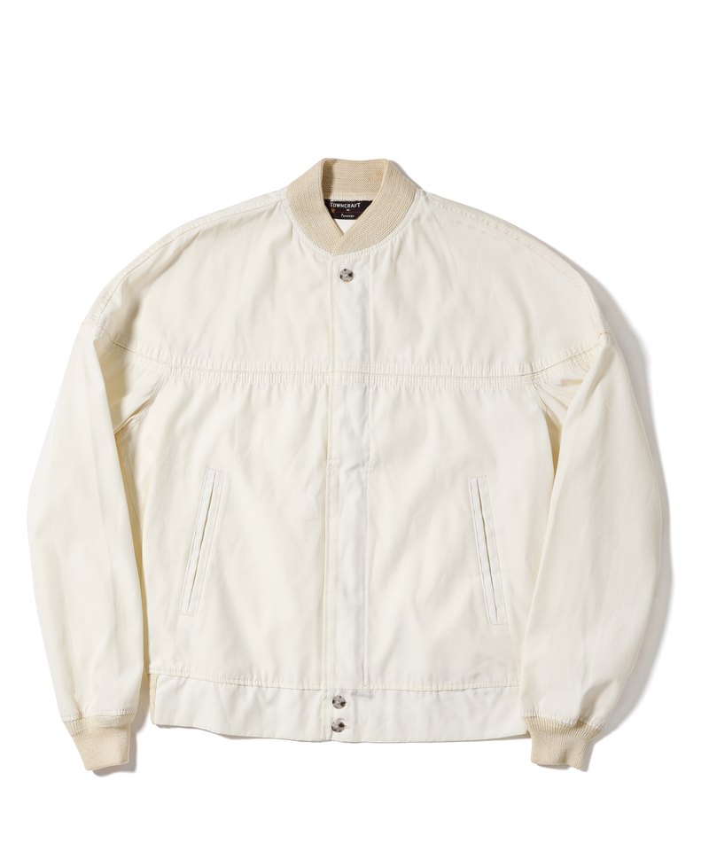 Front of a vintage off-white jacket made the same way as the orange one: rib-knit collar and cuffs, a placket that hides the front zipper, a seam across the chest and slanted pockets at the waist